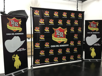 8' x 8' R&R Western Wear step-and-repeat backdrop with frame next to two matching roll-up banners printed in South Gate, CA