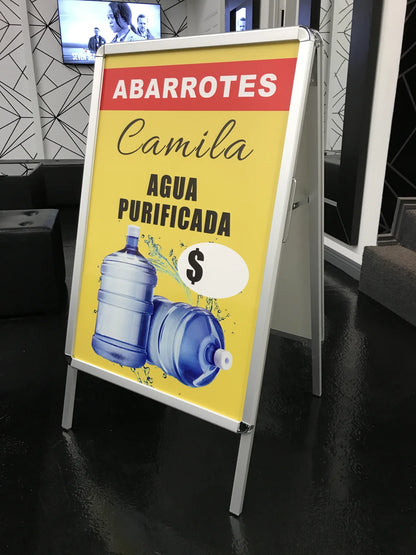 Double-sided A-frame sidewalk sign advertising purified water for a local grocery store, printed by Urban Tee LLC