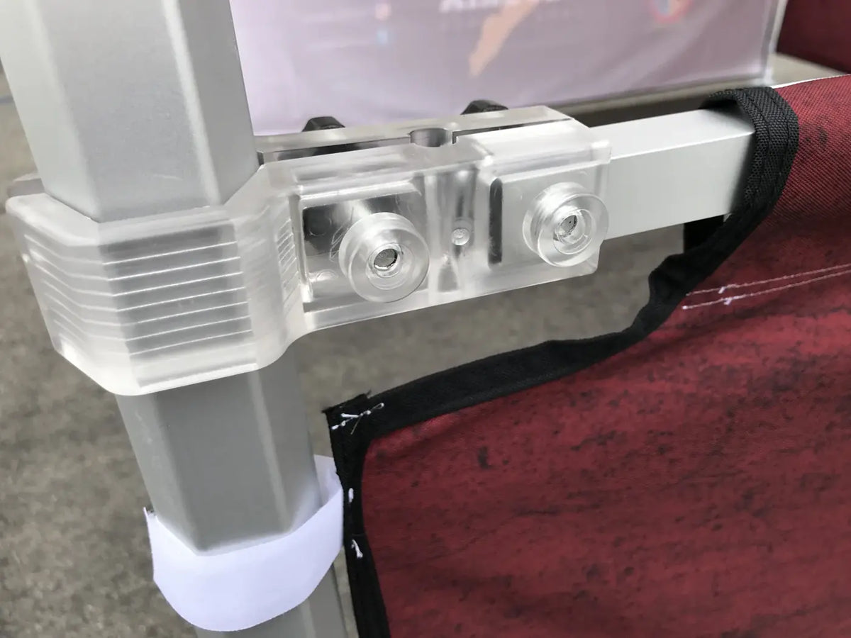 Close-up of a canopy half wall attached to the frame with a clear clamp and black reinforced edge