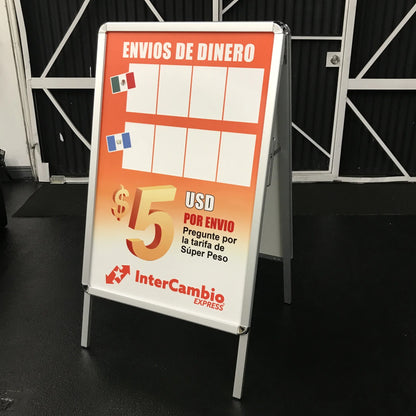 Double-sided A-frame sidewalk sign with orange money transfer poster, printed by Urban Tee LLC in South Gate, CA