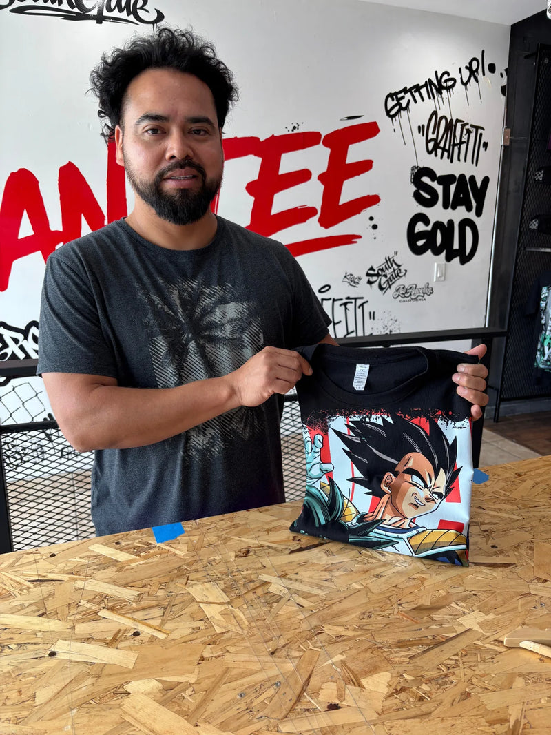 Customer holding up a black t-shirt with a full color anime character DTF transfer print at the Urban Tee LLC shop