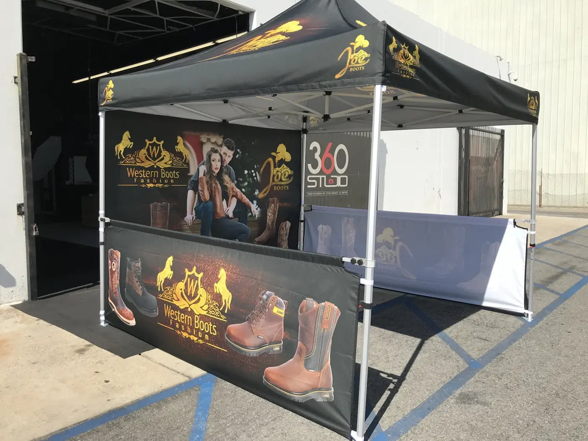 Black and gold custom printed canopy tent with a printed full back wall and two printed half walls
