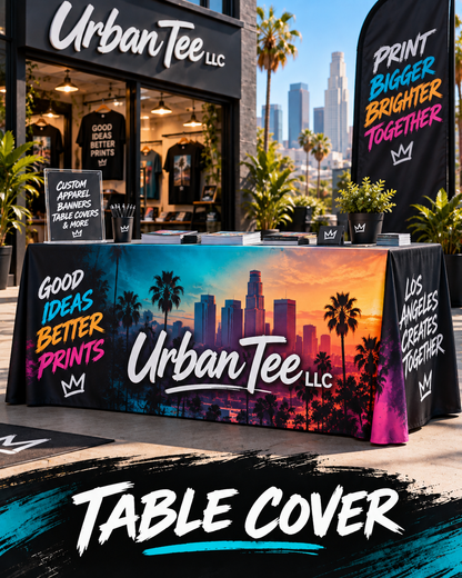 Custom printed fitted table cover with Urban Tee LLC logo and Los Angeles sunset design at an outdoor event booth