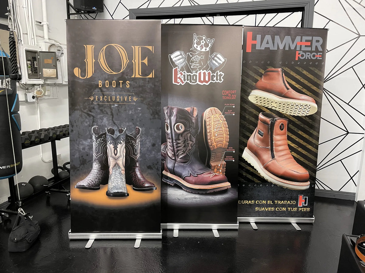 Three custom roll-up banners for western and work boot brands displayed in a showroom, printed by Urban Tee LLC in Los Angeles