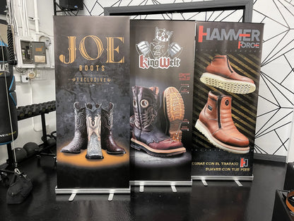Three custom roll-up banners for western and work boot brands displayed in a showroom, printed by Urban Tee LLC in Los Angeles