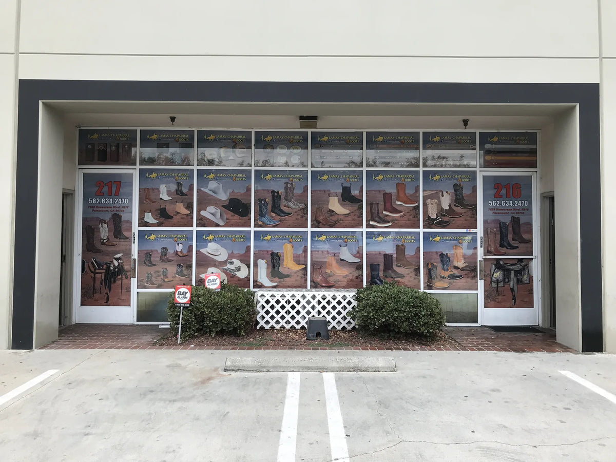 Custom window perforation graphics covering a western boot store storefront, printed by Urban Tee LLC near South Gate, CA