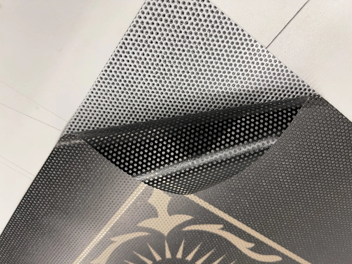 Close-up of one-way vision perforated vinyl showing the printed side and see-through black backing