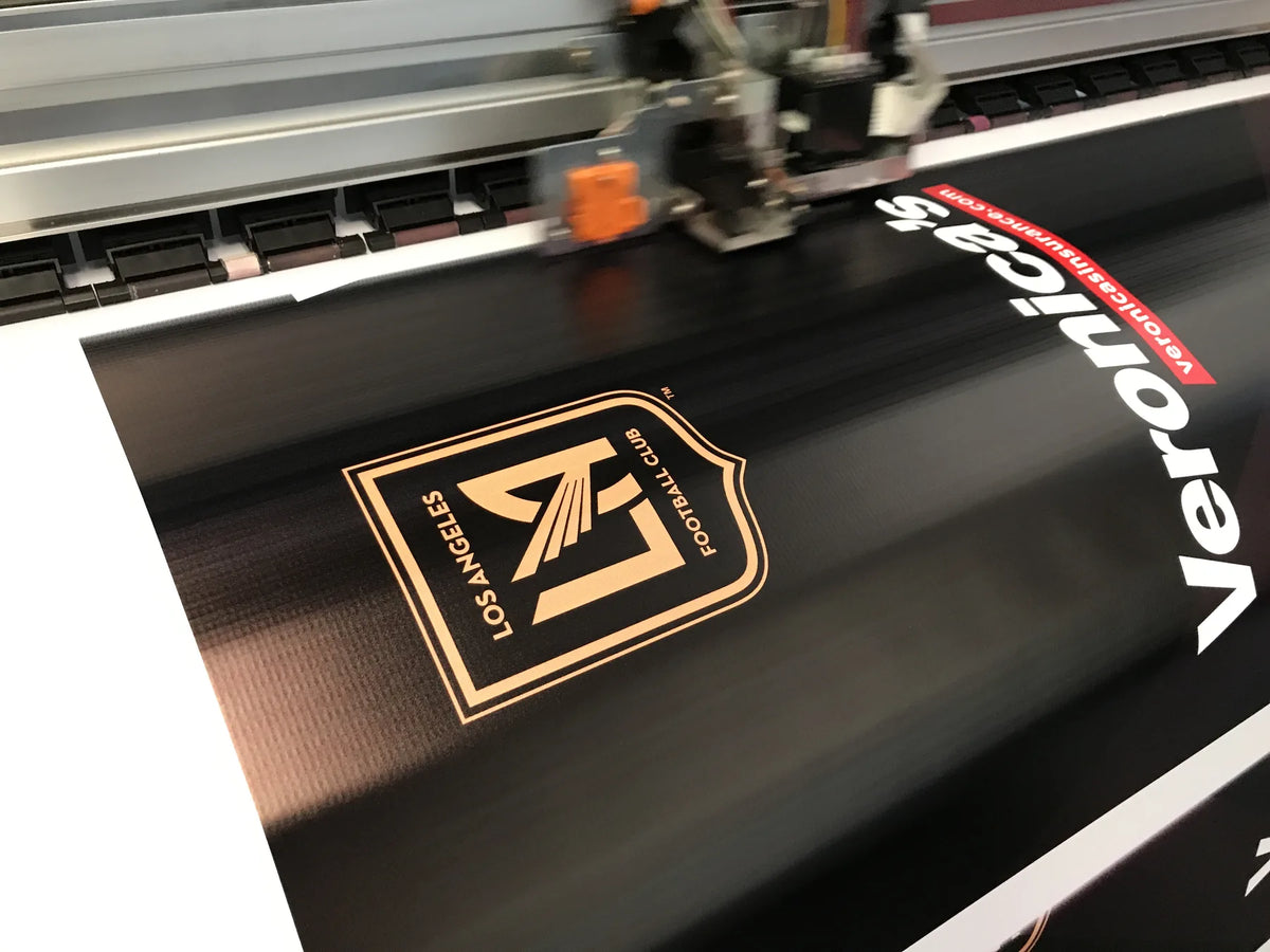 Custom vinyl banner printing on a large format printer at Urban Tee LLC, serving South Gate and Los Angeles