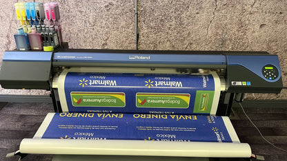 Roland large format printer printing custom window perforation graphics at Urban Tee LLC, serving South Gate and Los Angeles